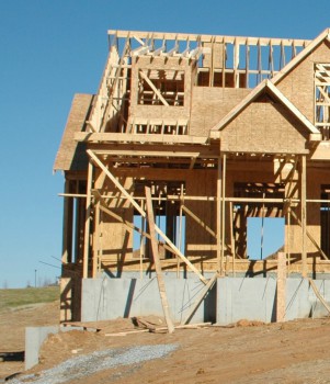 House being constructed with exposed lumber and concrete